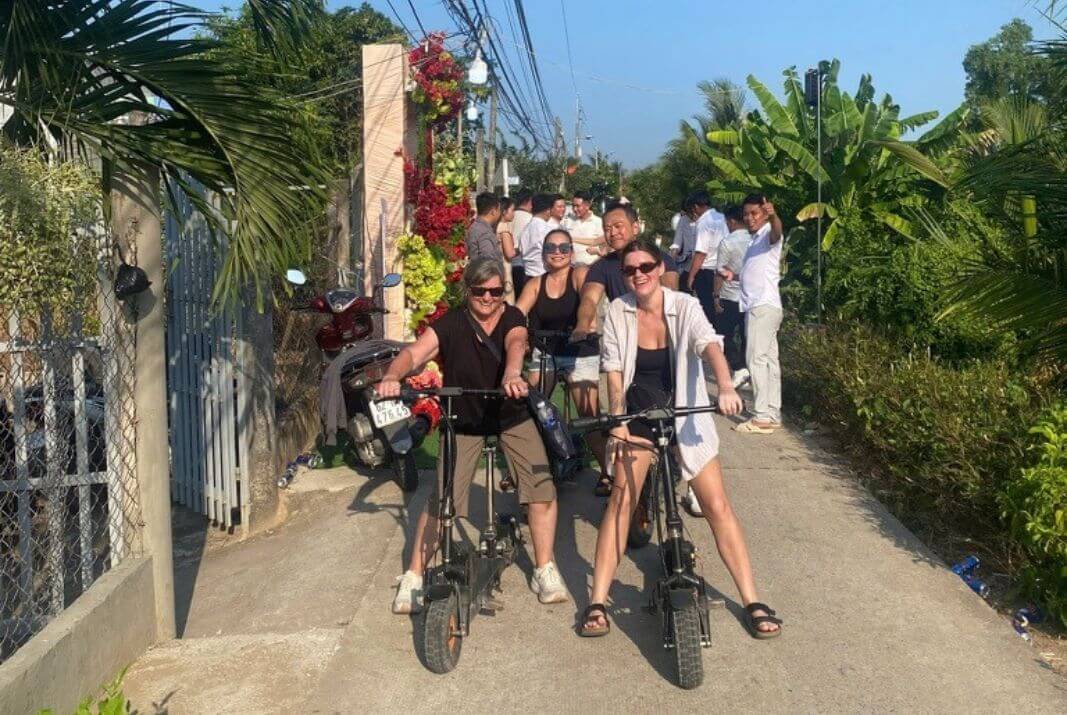 Riding e-scooter past a local wedding