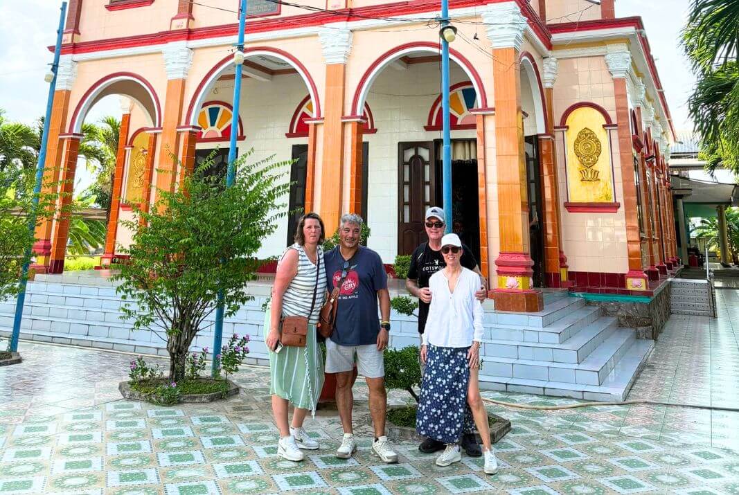 The tourists standing outside the local Cao Dai temple in Mekong Delta