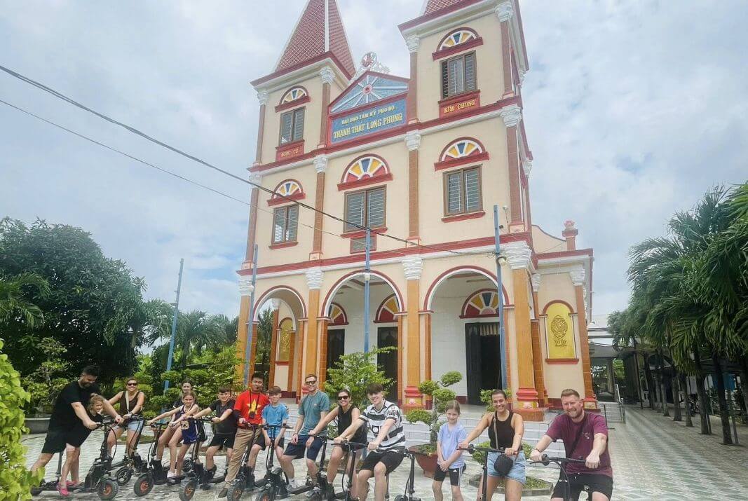 Visitors at the entrance of a Cao Dai temple