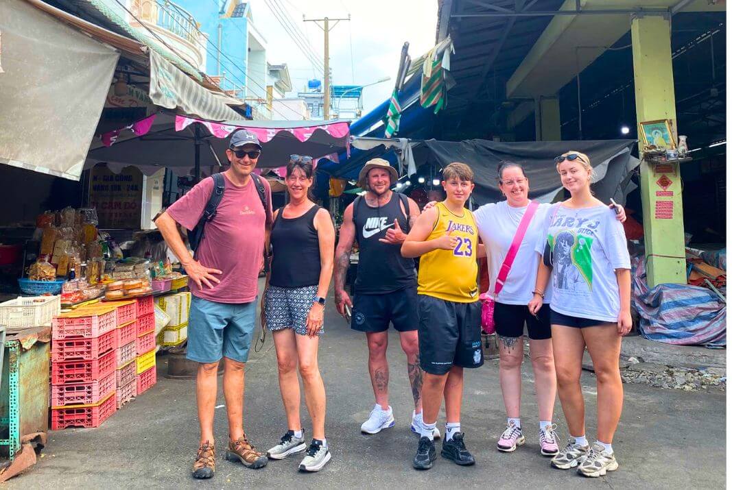 Travelers at a local market in Vietnam, experiencing daily life and local culture.