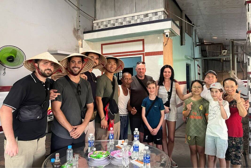 Group photo with a rice wine making family travellers and heritage rice-wine maker woman's family